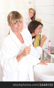 Young women brushing their teeth