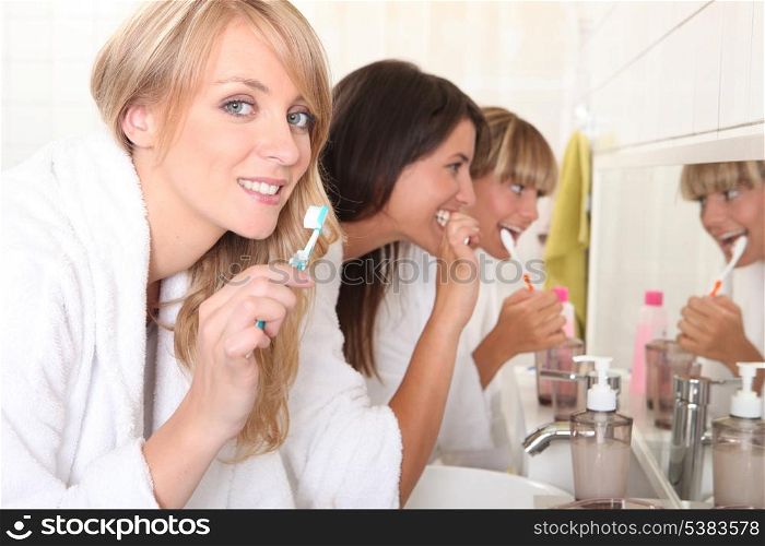 Young women brushing their teeth