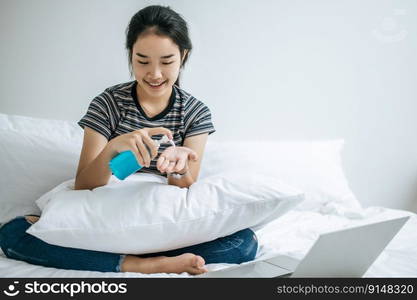 Young women clean their hands with a hand wash gel to prevent germs.