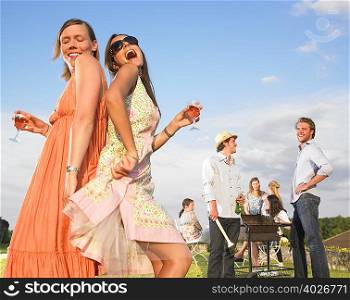 young women dancing at barbecue