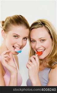 Young women eating lollipops