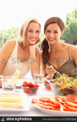 Young women eating outdoors