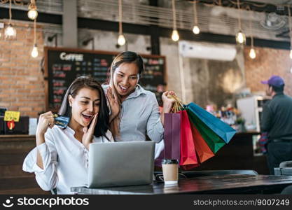 
Young women enjoy shopping with credit cards.