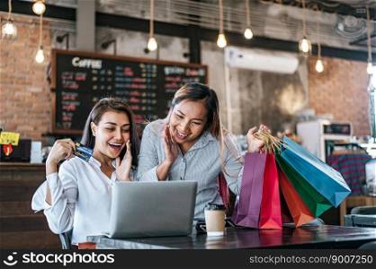  Young women enjoy shopping with credit cards.