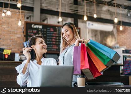 
Young women enjoy shopping with credit cards.