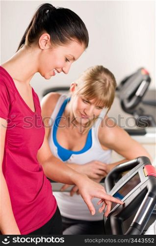 Young women exercising at fitness center on treadmill machine
