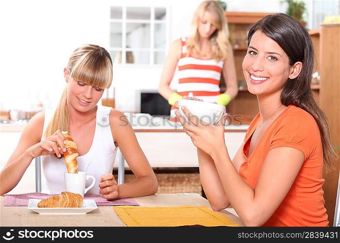 Young women having breakfast at home