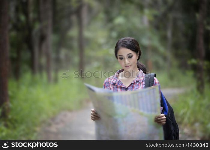 Young Women Hikers Looking At Map and Relax time on holiday concept travel in forest