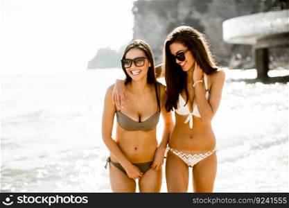 Young women in a bikini having fun at the beach