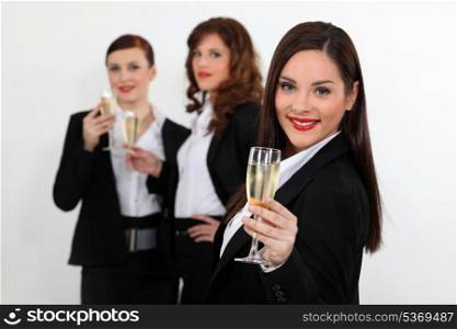 Young women in smart suit with glasses of champagne