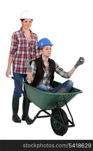 Young women laborers with a wheelbarrow