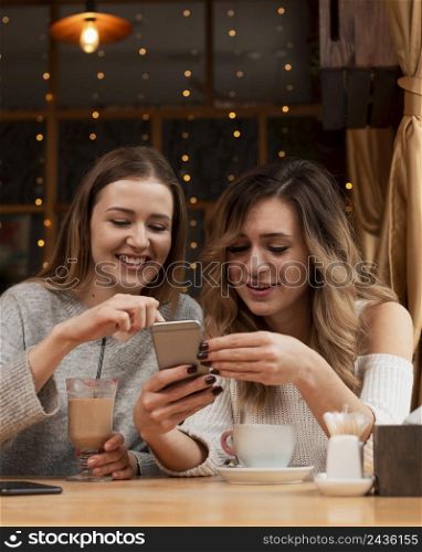 young women looking phone