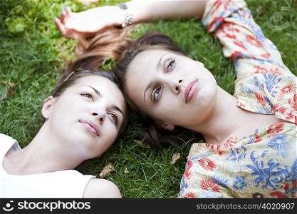 Young women lying in grass