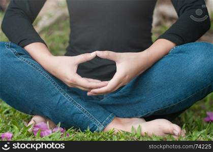 Young women make meditation with green background, yoga and wellness concept.
