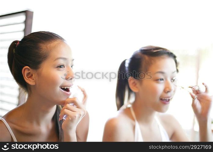 Young women making up