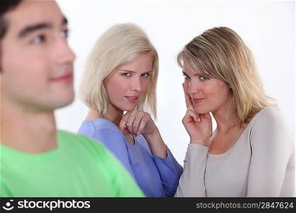 Young women observing a man
