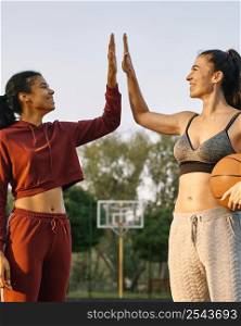 young women playing basketball