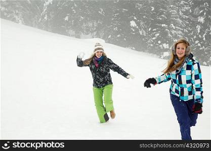 Young women playing in snow, Sattelbergalm, Tirol, Austria