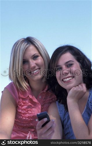 Young Women Playing with a Cell Phone