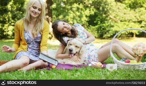 Young women playing with friendly dog
