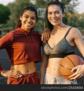 young women posing with basketball