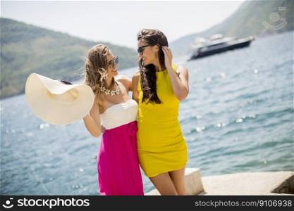 Young women relaxing on sea shore  at hot summer day