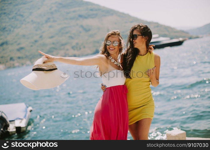 Young women relaxing on sea shore  at hot summer day