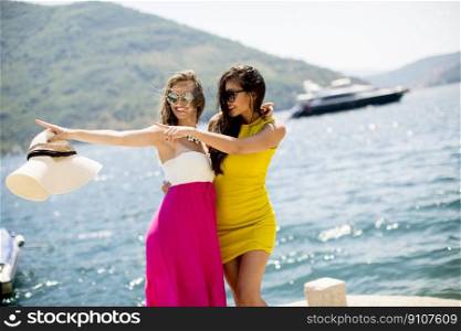 Young women relaxing on sea shore  at hot summer day