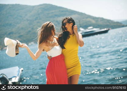 Young women relaxing on sea shore  at hot summer day