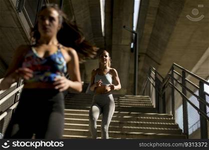 Young women running alone down stairs  outdoor in urban environment