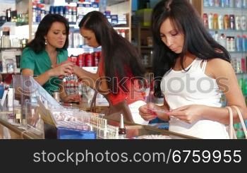Young Women Shopping in Cosmetics Store, Choosing Nail Polish
