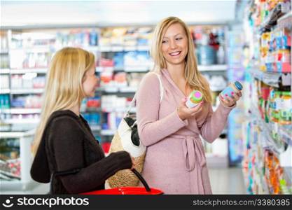 Young women shopping together in the supermarket