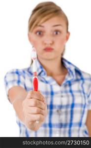 Young women showing the toothbrush on a white background
