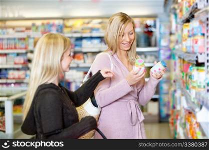 Young women smiling while shopping together in the supermarket