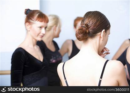 Young women stand in ballet rehearsal room