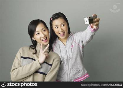 Young women taking photo of themselves