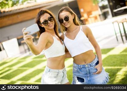Young women taking selfie outdoor at hot summer day