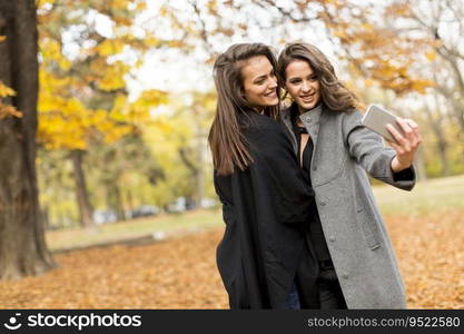 Young women taking selfie with smartphone outdoor