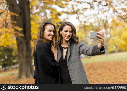 Young women taking selfie with smartphone outdoor