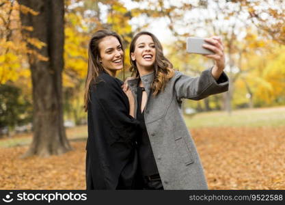 Young women taking selfie with smartphone outdoor