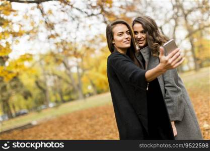 Young women taking selfie with smartphone outdoor