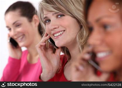 Young women talking on their mobile phones