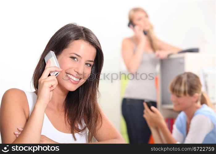 Young women using cellphones