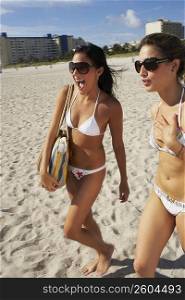 Young women walking on the beach