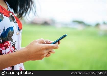 Young women wear colorful clothes and play  a smartphone