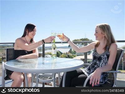 young women with glass of wine in outdoors cafe or restaurant