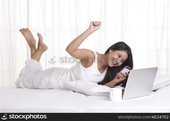 Young WOMEN with her cell phone and laptop