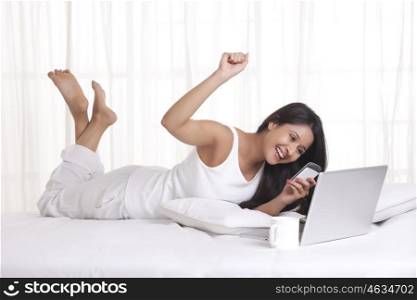 Young WOMEN with her cell phone and laptop
