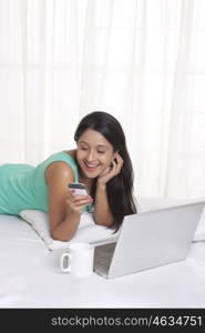 Young WOMEN with her cell phone and laptop