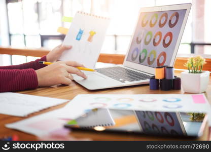 young women working as fashion designer choosing colour for drawing sketches for clothes in atelier paper at workplace studio